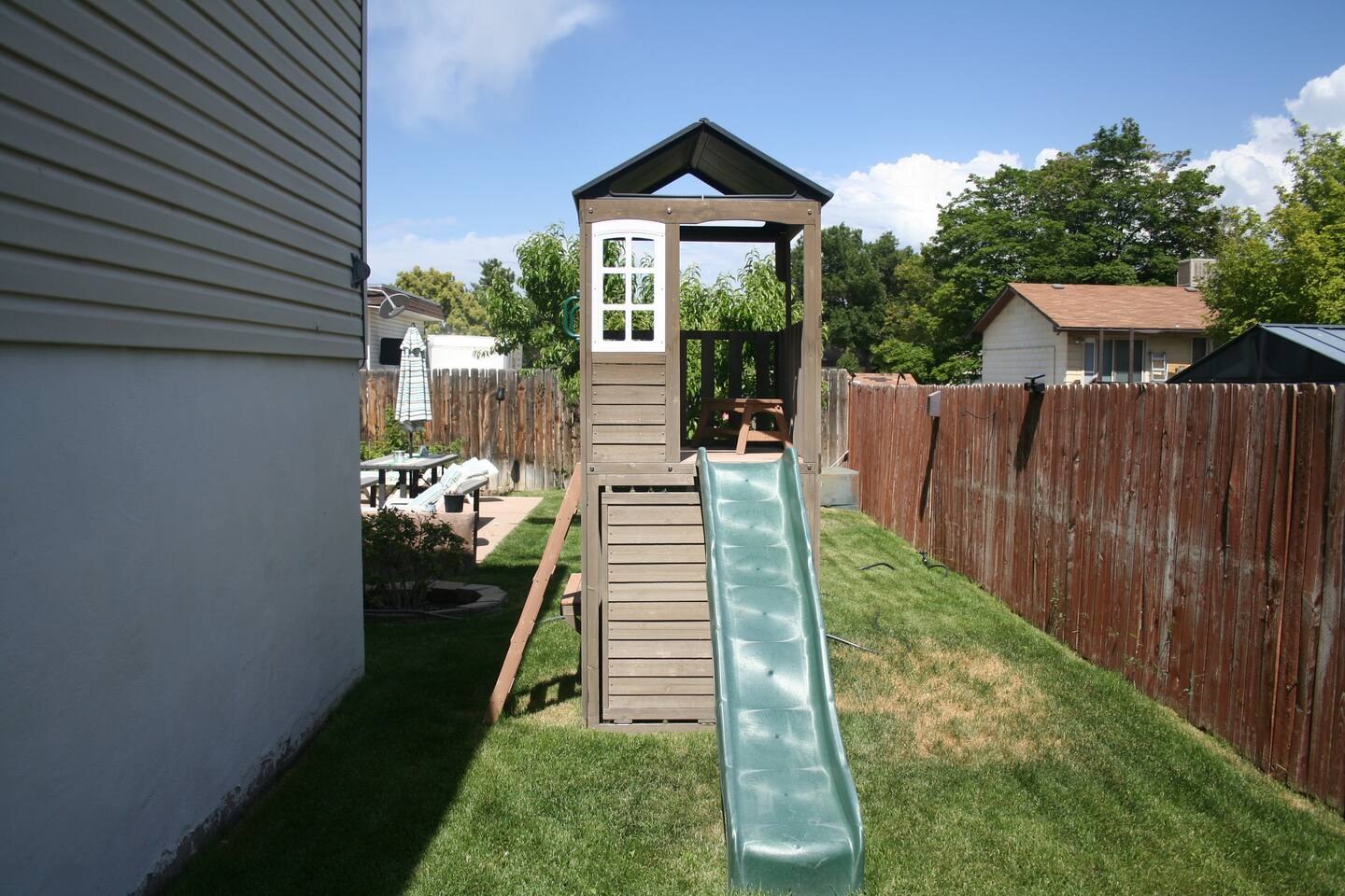 Backyard play structure with a slide